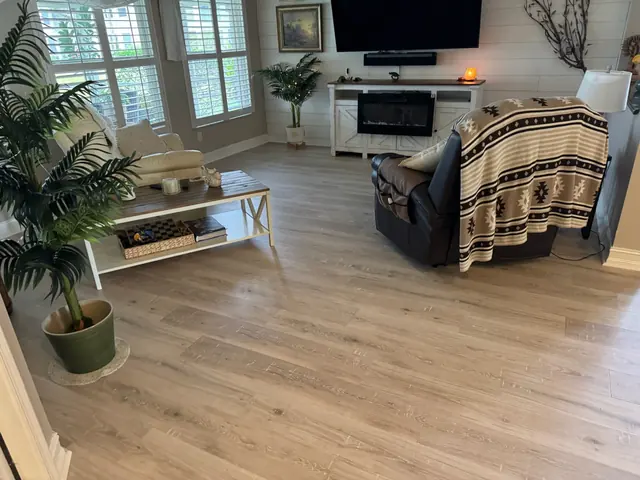 Living room with light oak-look vinyl plank flooring installed by Rauen Floor